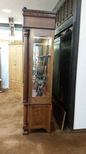 Antique reproduction gun cabinet side view